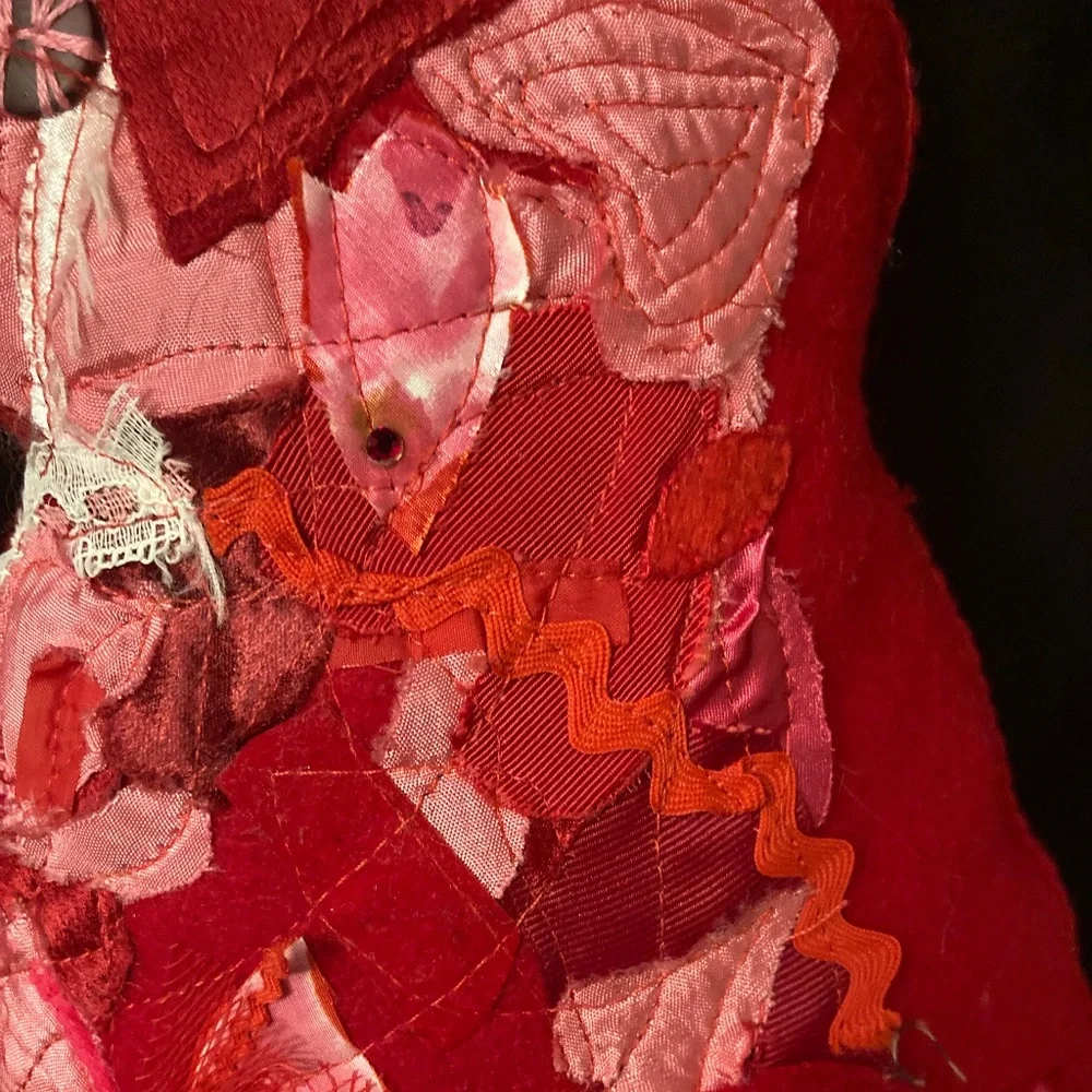 Felted cat pillow with apliqued and stitched designs. Vintage fabric and button.